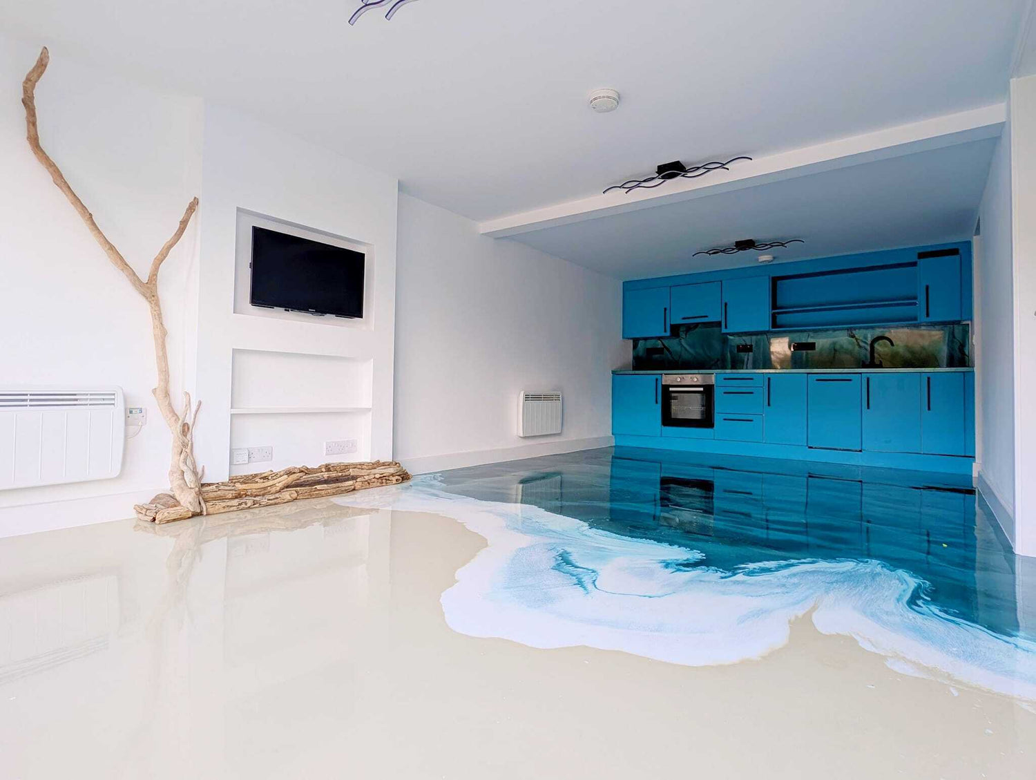 A beach-themed epoxy floor inside a villa with a cabinets in the background