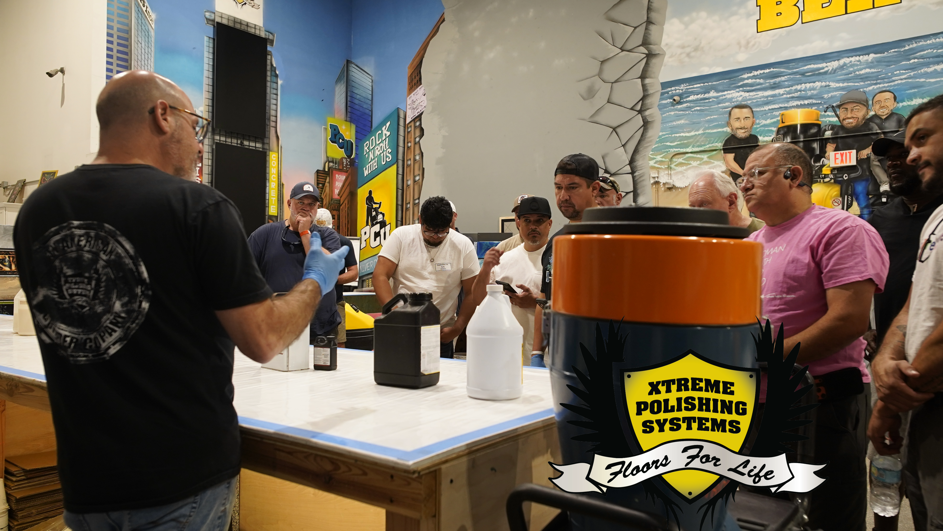 An epoxy resin contractor teaching students how to price epoxy jobs in a warehouse setting.