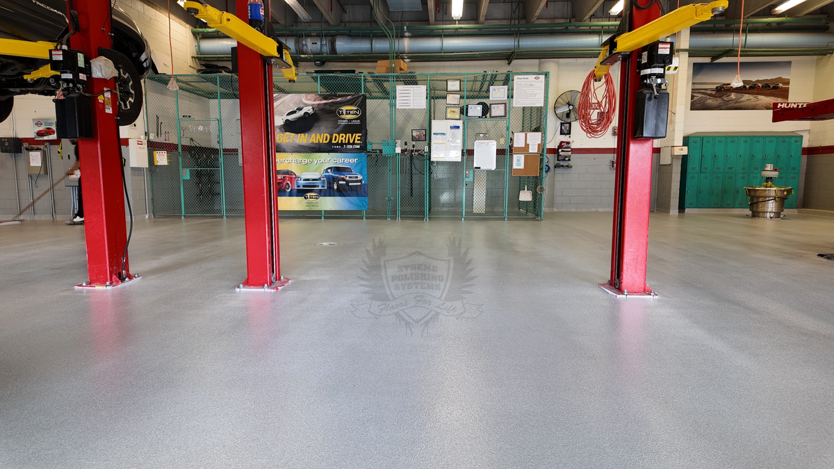 A polished concrete resinous coating installing in a commercial mechanic's garage.