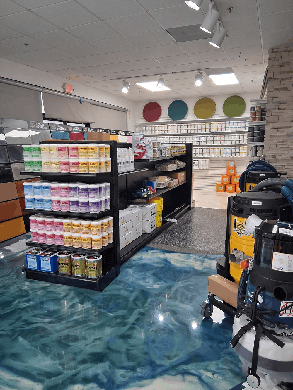 Blue epoxy floor in large interior space | XPS - xtreme polishing systems, chantilly flooring, polishing store, flooring supplies, and concrete floor shop. Epoxy stores.