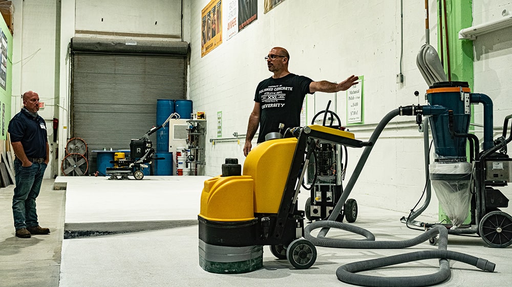 contractor instructing class using floor polishing and grinding machine | XPS
