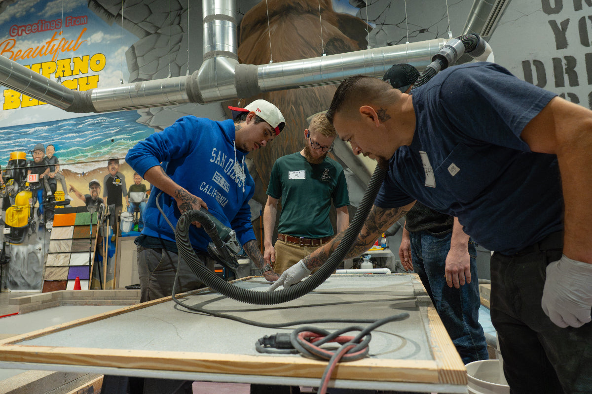 epoxy training students working on a slab with angle grinder
