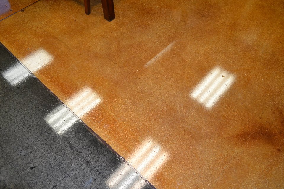Decorative concrete floor with gold/ orange and gray colors. Amazing commercial floor epoxy and concrete floor supply.