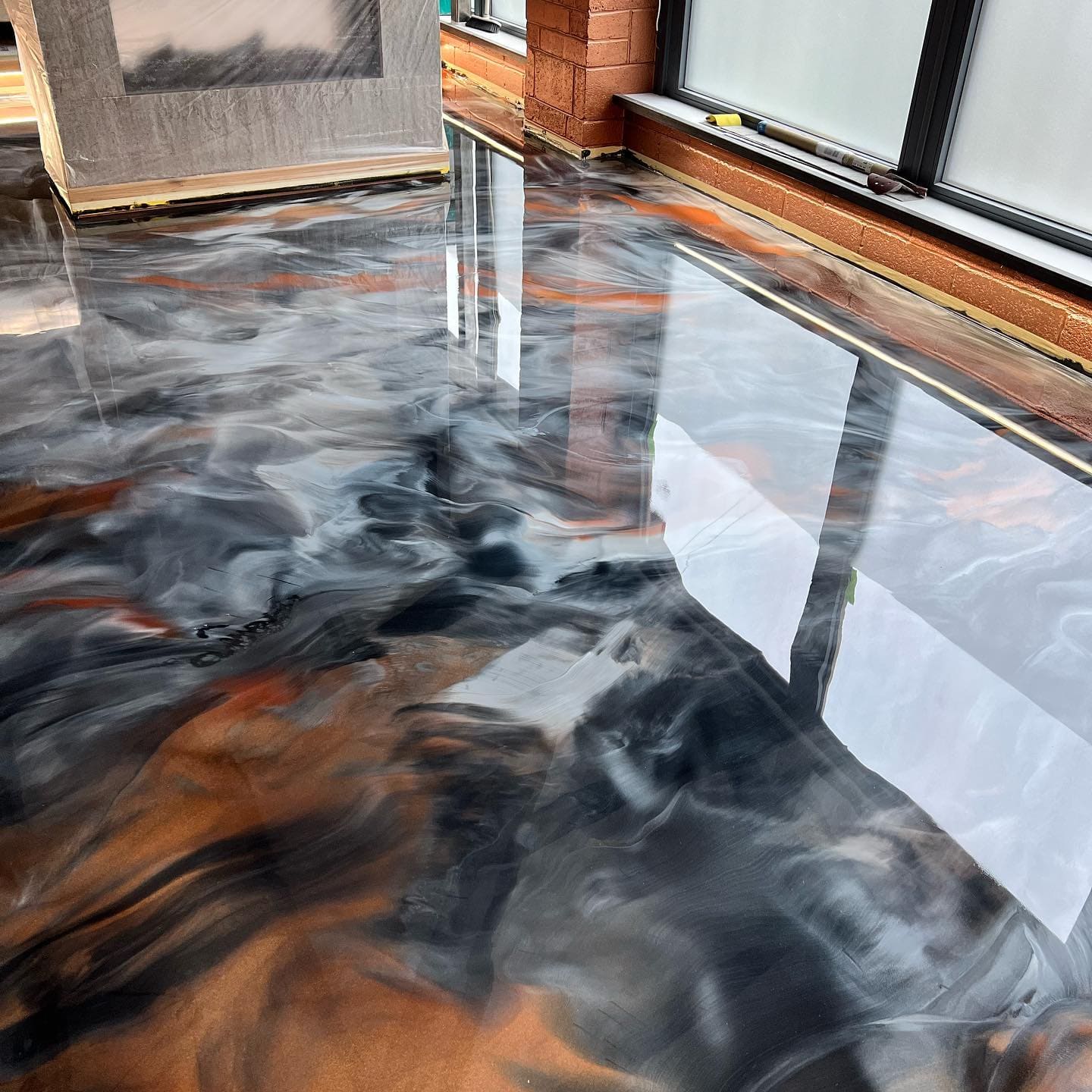 Orange and black metallic epoxy floor. Clear epoxy coatings that are great as a garage floor epoxy kit, clear epoxy coating, and epoxy floor kits.