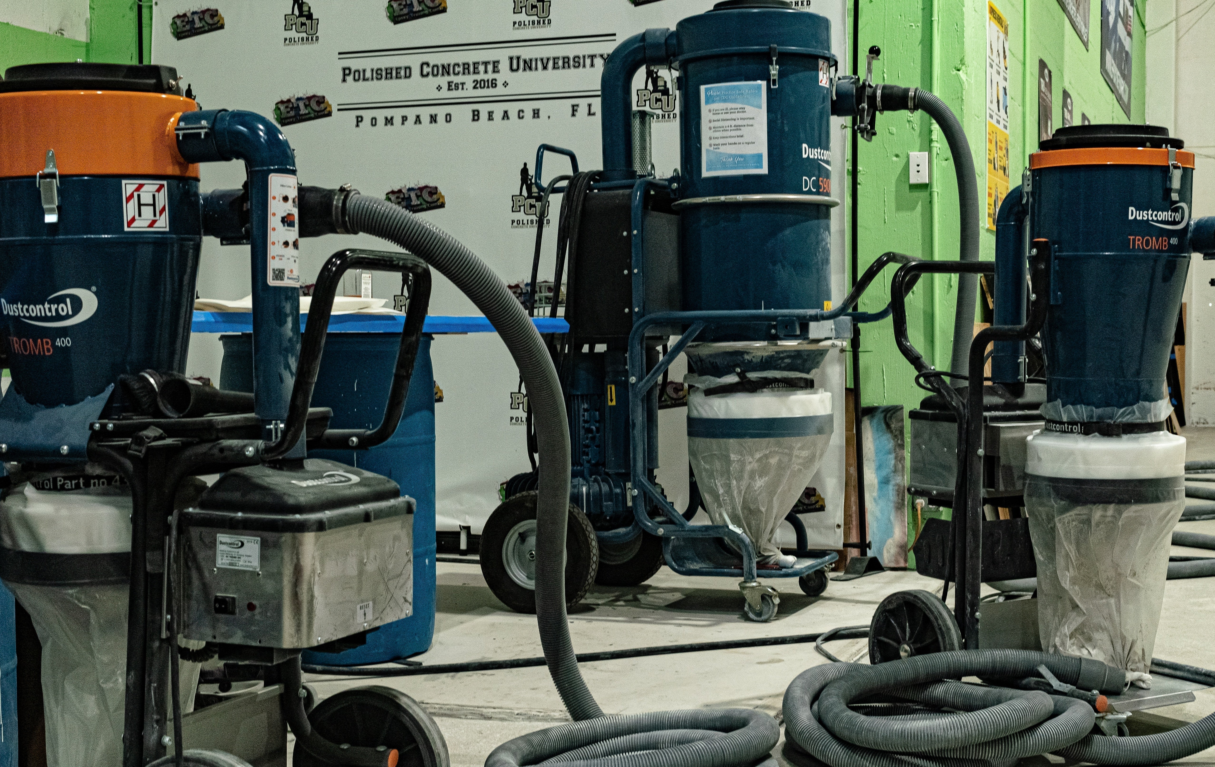 A collection of three Tromb 400 Dustless polished concrete vacuums in the Polished Concrete University warehouse.