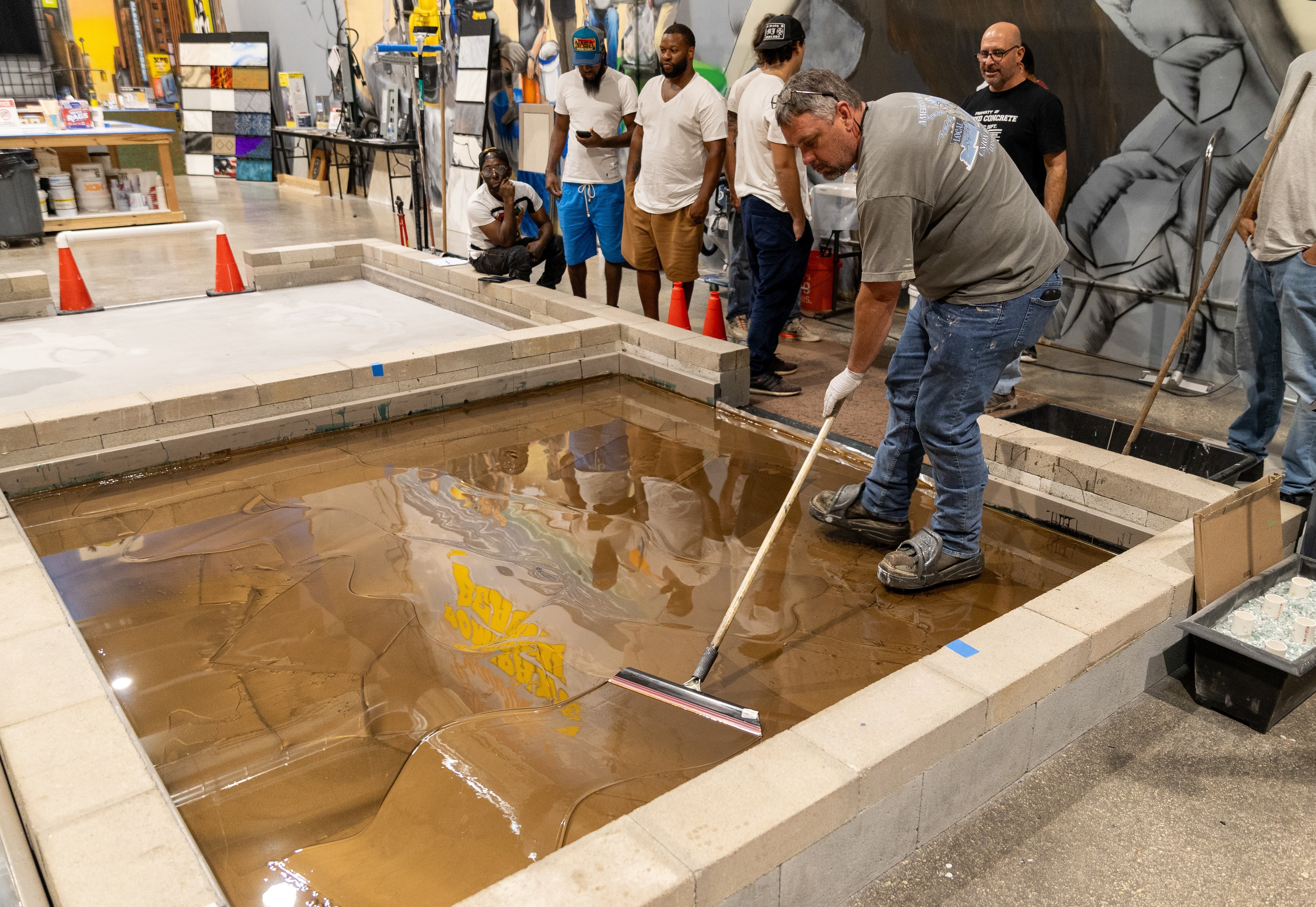 Contractors in an epoxy training course learning how to stop concrete moisture.