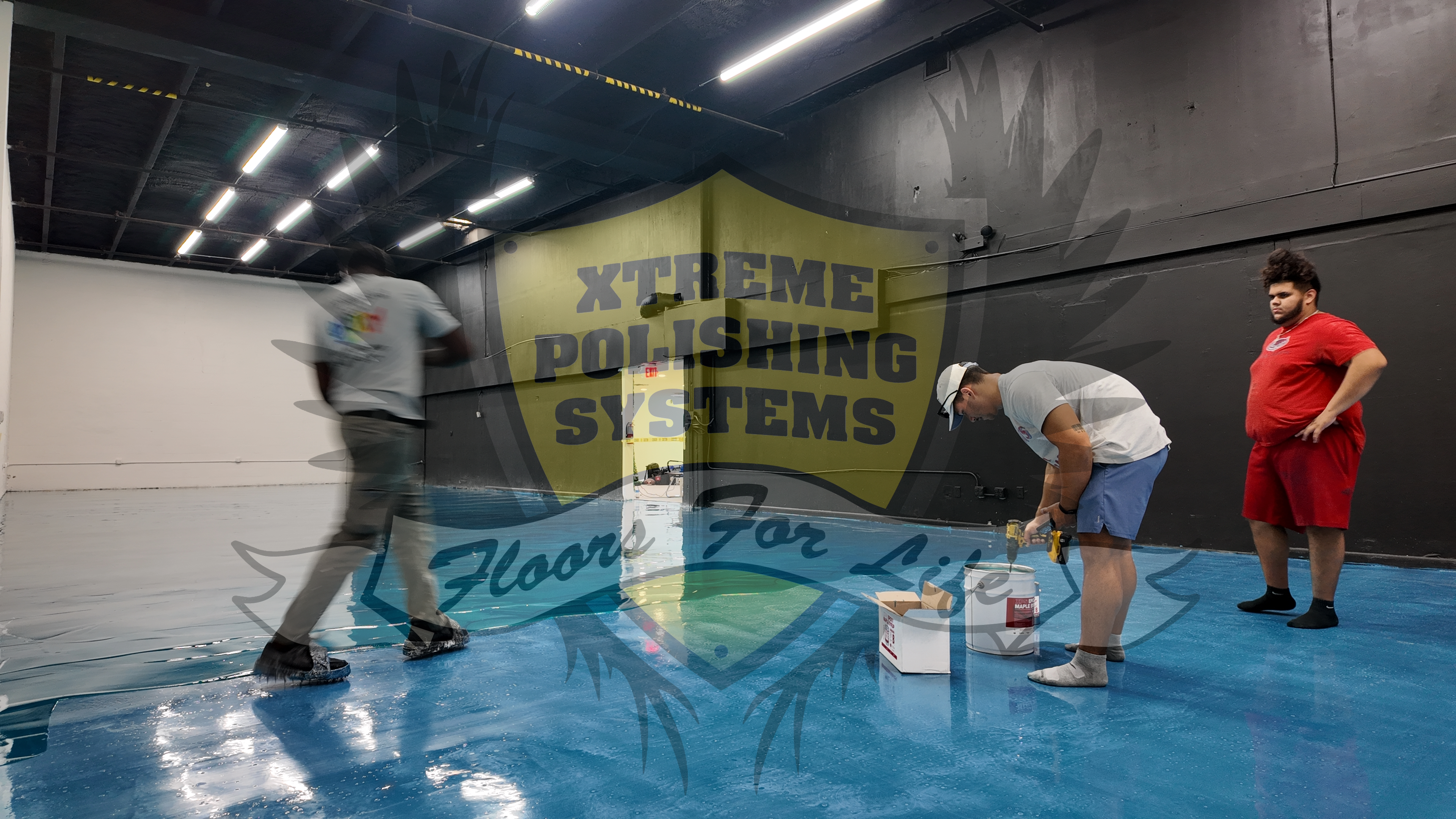 A resinous coating installation of a metallic blue resin in a warehouse setting.