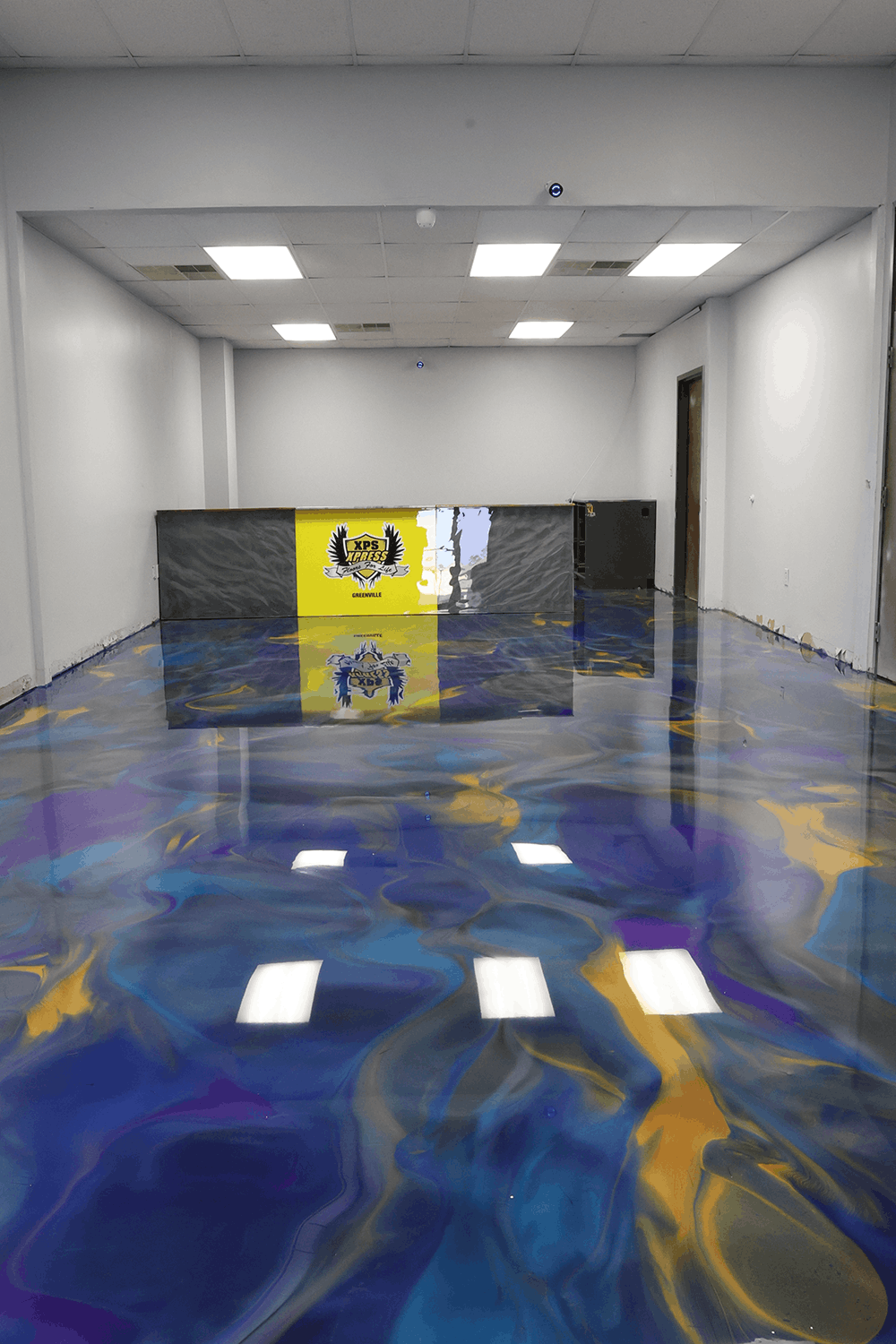 XPS Pensacola. Blue, purple, and yellow epoxy floor.
