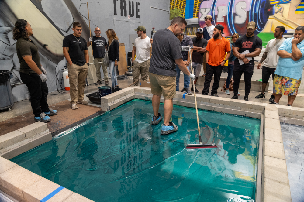 Turquoise epoxy floor in epoxy coating training class.