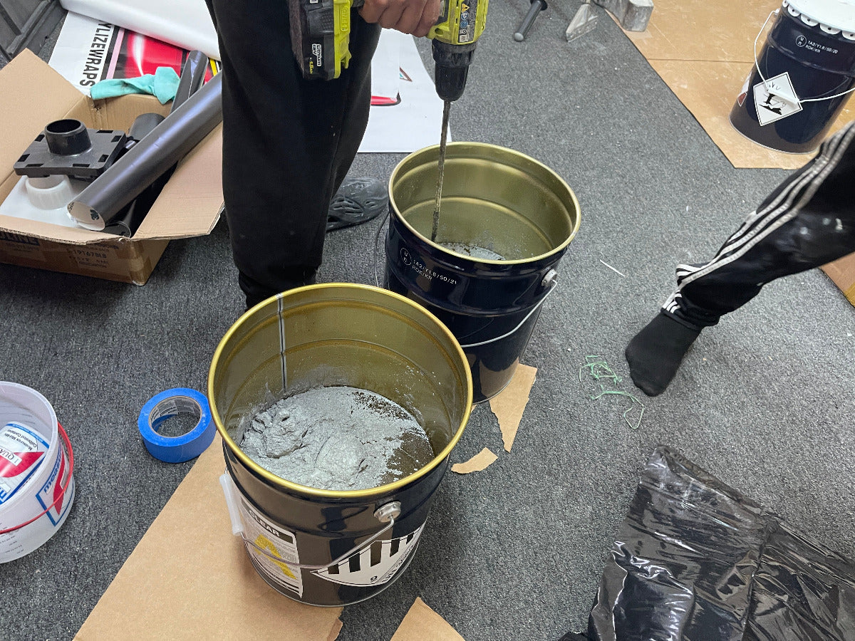 XPS pros mixing epoxy with drill on job site.